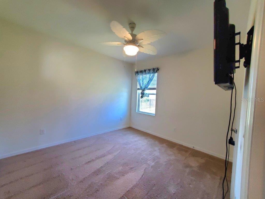 25525 Gorham Lane Punta Gorda, FL 33950 - Photo 14 of 34 an empty room with a window and a fan