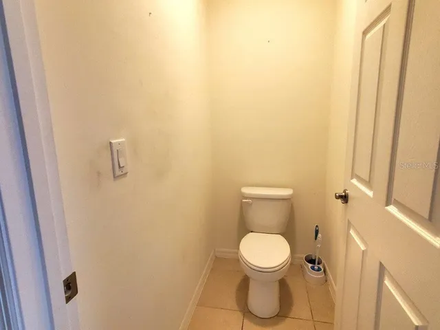 a white toilet sitting next to a shower