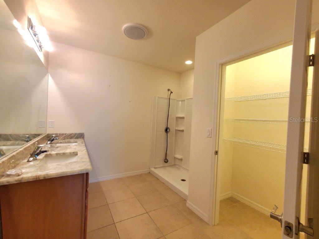 25525 Gorham Lane Punta Gorda, FL 33950 - Photo 18 of 34 a bathroom with a granite countertop sink a mirror and shower