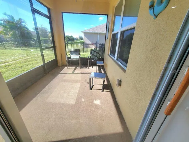 a view of a living room with a floor to ceiling window and floor to ceiling window