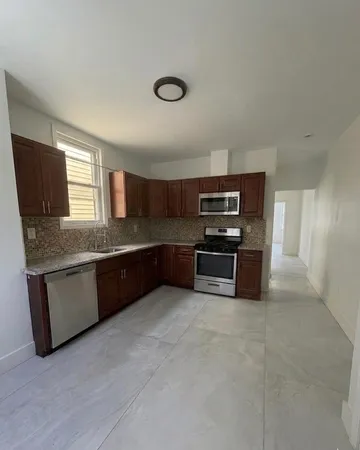 a kitchen with stainless steel appliances granite countertop a stove and a sink