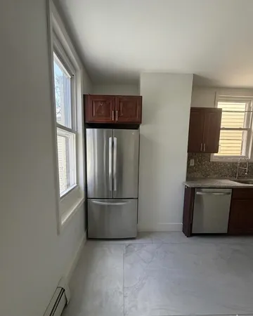a kitchen with a sink a microwave and cabinets