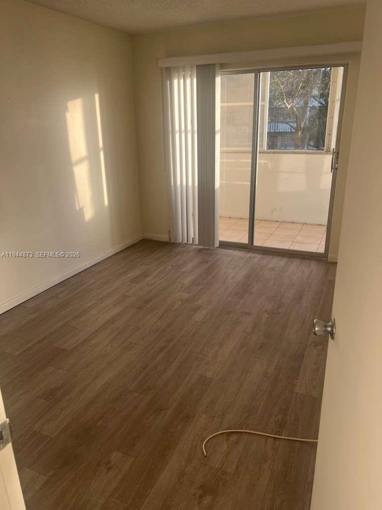 528 Mansfield M, Unit 528 Boca Raton, FL 33434 - Photo 13 of 14 an empty room with windows and closet