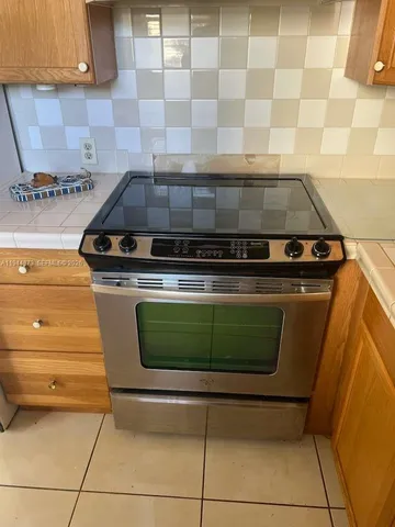 a stove top oven sitting inside of a kitchen