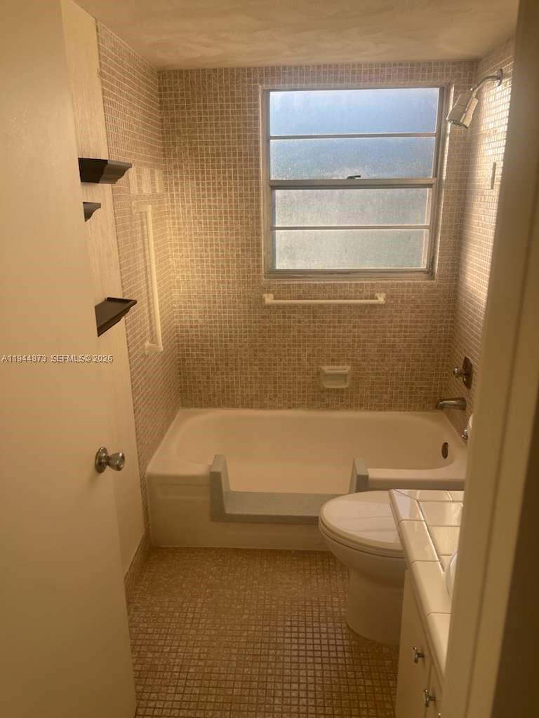 528 Mansfield M, Unit 528 Boca Raton, FL 33434 - Photo 8 of 14 a bathroom with a tub and a shower
