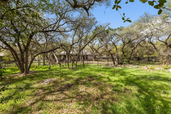 a backyard of a house with lots of trees