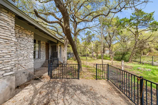 a backyard of a house with table and chairs