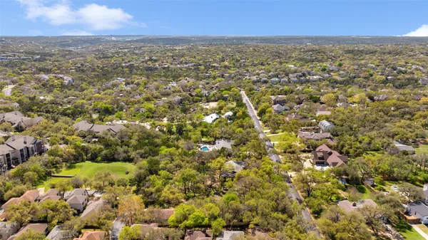 an aerial view of residential houses with city view