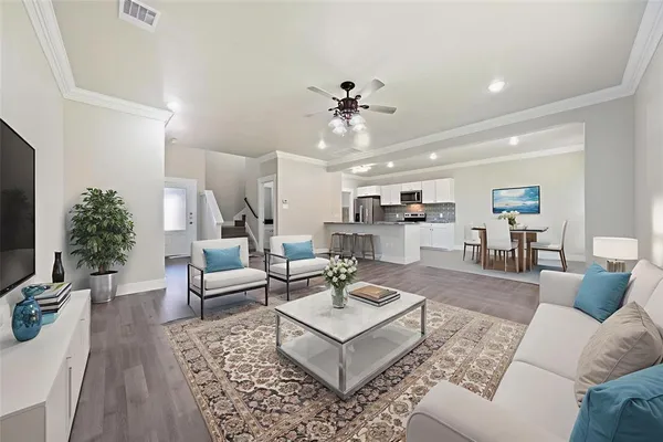 a living room with furniture and view of kitchen