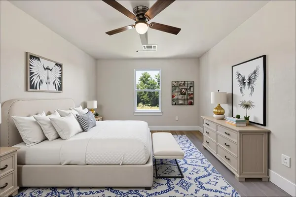 a bedroom with a large bed and a window
