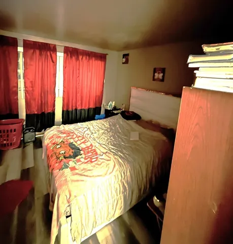 a bed sitting in a bedroom next to a window