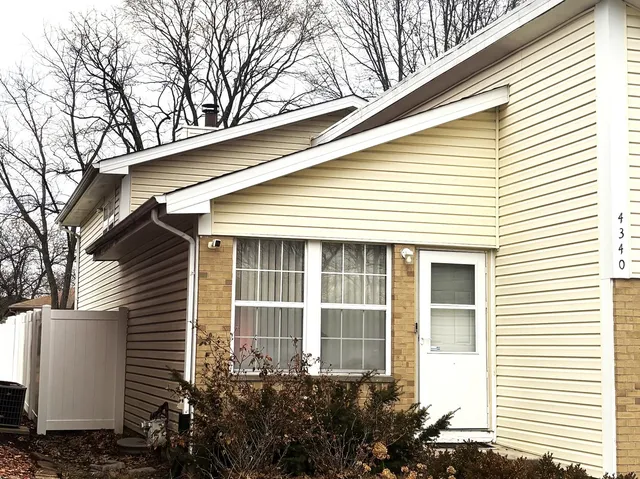 a view of a house with a yard and potted plants