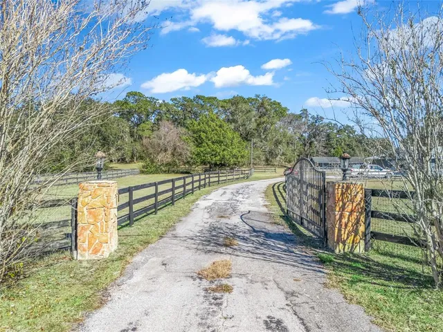 an aerial view of a house with garden space and street view