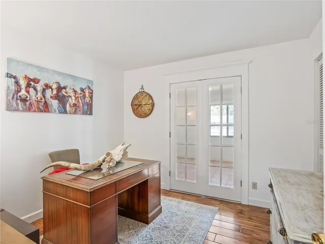 a room with a bed and a wooden floor