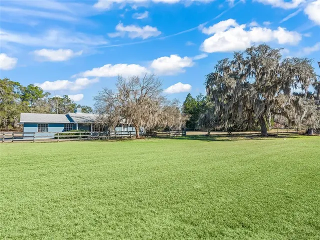 a view of a house with swimming pool and sitting area