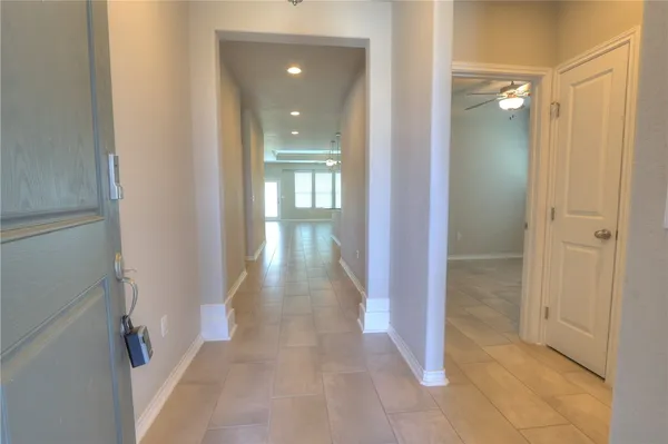 a view of a hallway with a glass door and entryway