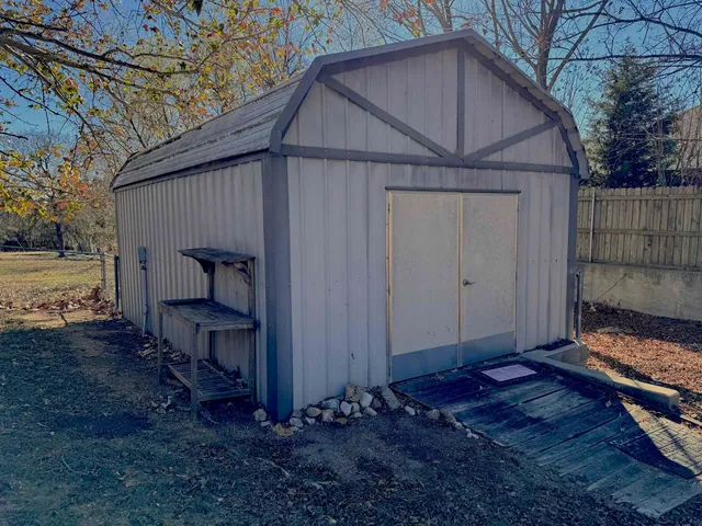 a wooden bench sitting in front of a house