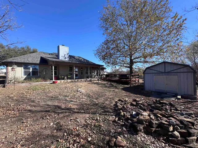 a front view of house with a garden