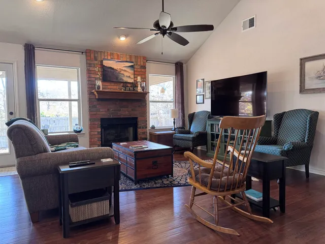 a living room with furniture a flat screen tv and a fireplace