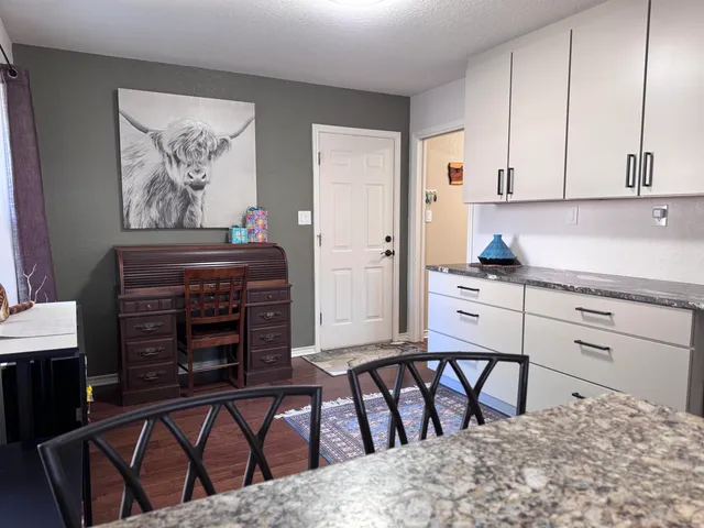 a kitchen with a table chairs and a refrigerator