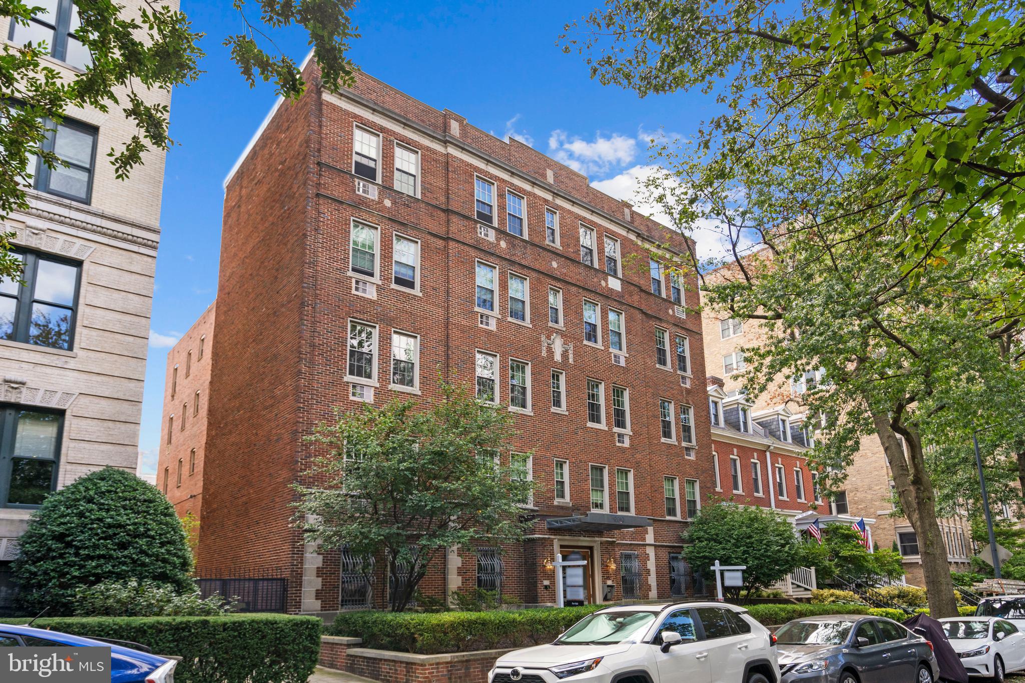 2010 Kalorama Road Northwest, Unit 306 Washington, DC 20009 - Photo 2 of 26 a front view of a building with lot of cars and trees