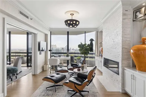 a living room with furniture and a chandelier