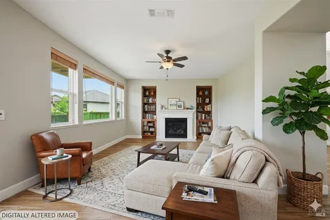 a living room with furniture a fireplace and a potted plant