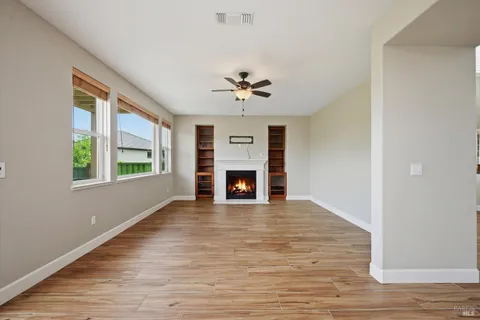wooden floor fireplace and windows in a room