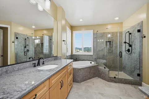 a bathroom with a double vanity sink mirror double and shower