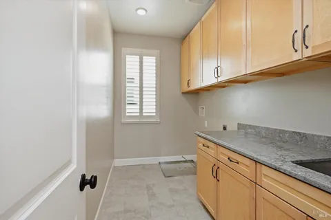 a kitchen with granite countertop cabinets and window