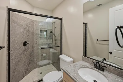 a bathroom with a sink toilet and shower