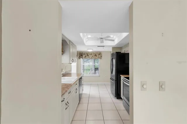 a hallway with a white cabinets and wooden floor