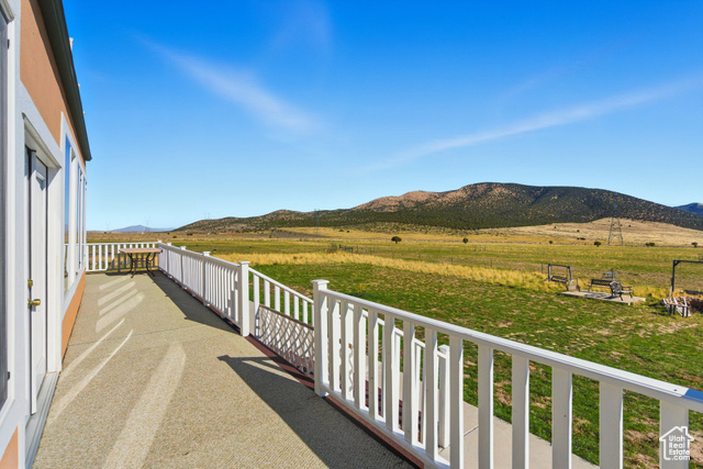 4768 East Hickman Canyon Road Stockton, UT 84071 - Photo 54 of 85 Deck with a mountain view and a view of countryside.