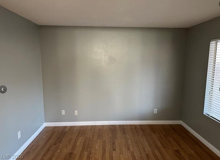 7652 Kalmalii Avenue Las Vegas, NV 89147 - Photo 6 of 9 Hardwood floors and generous natural light define this inviting room.