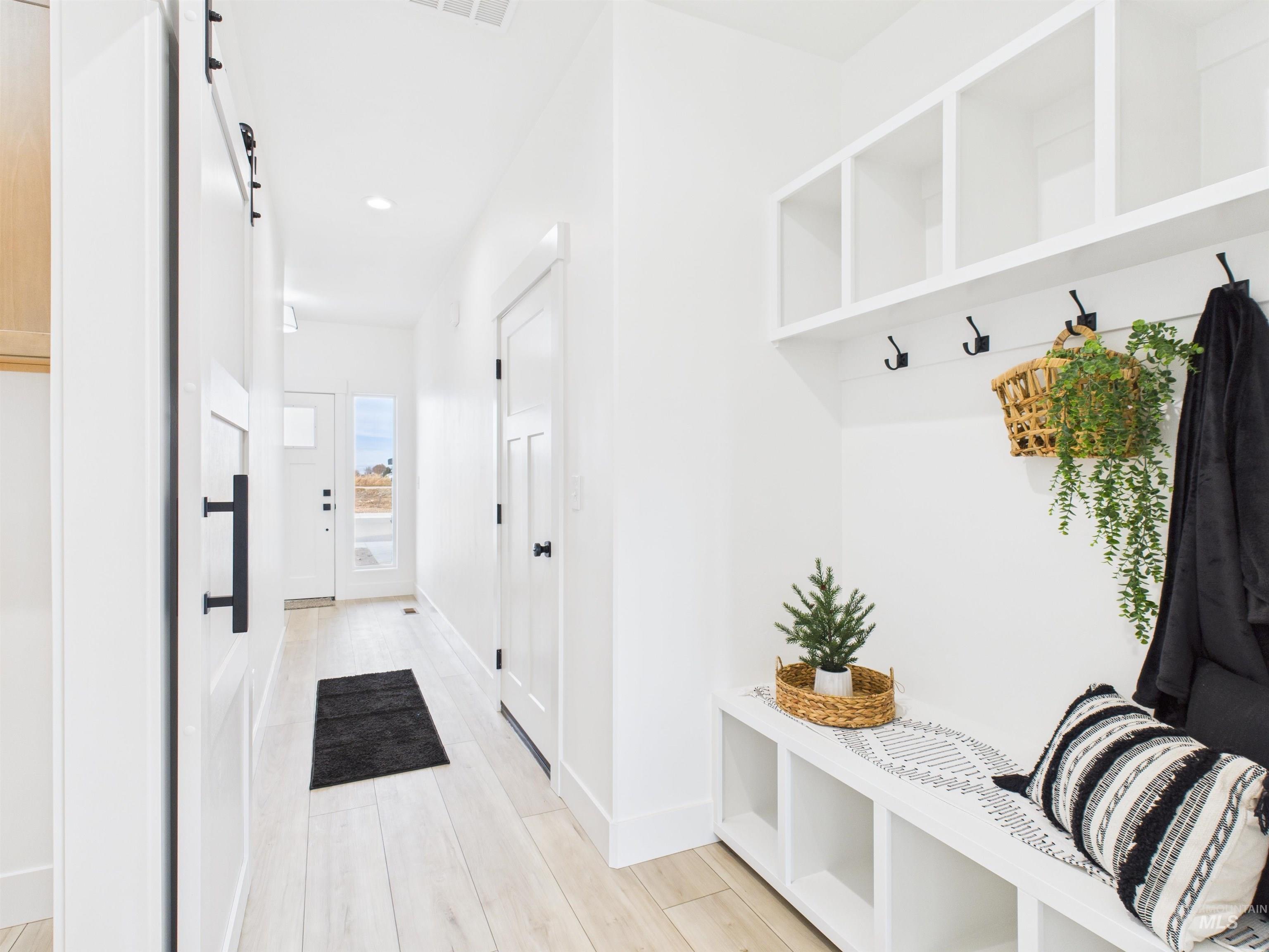 1211 Bronze Rupert, ID 83350 - Photo 5 of 30 Mudroom with a barn door, light wood-style floors, and recessed lighting