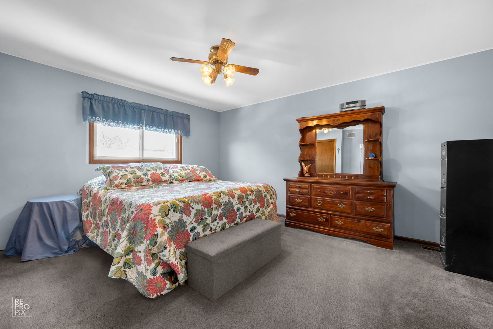 3235 192nd Street Lansing, IL 60438 - Photo 7 of 28 a bedroom with a bed and a chandelier