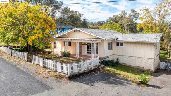 a view of a house with a yard and sitting area