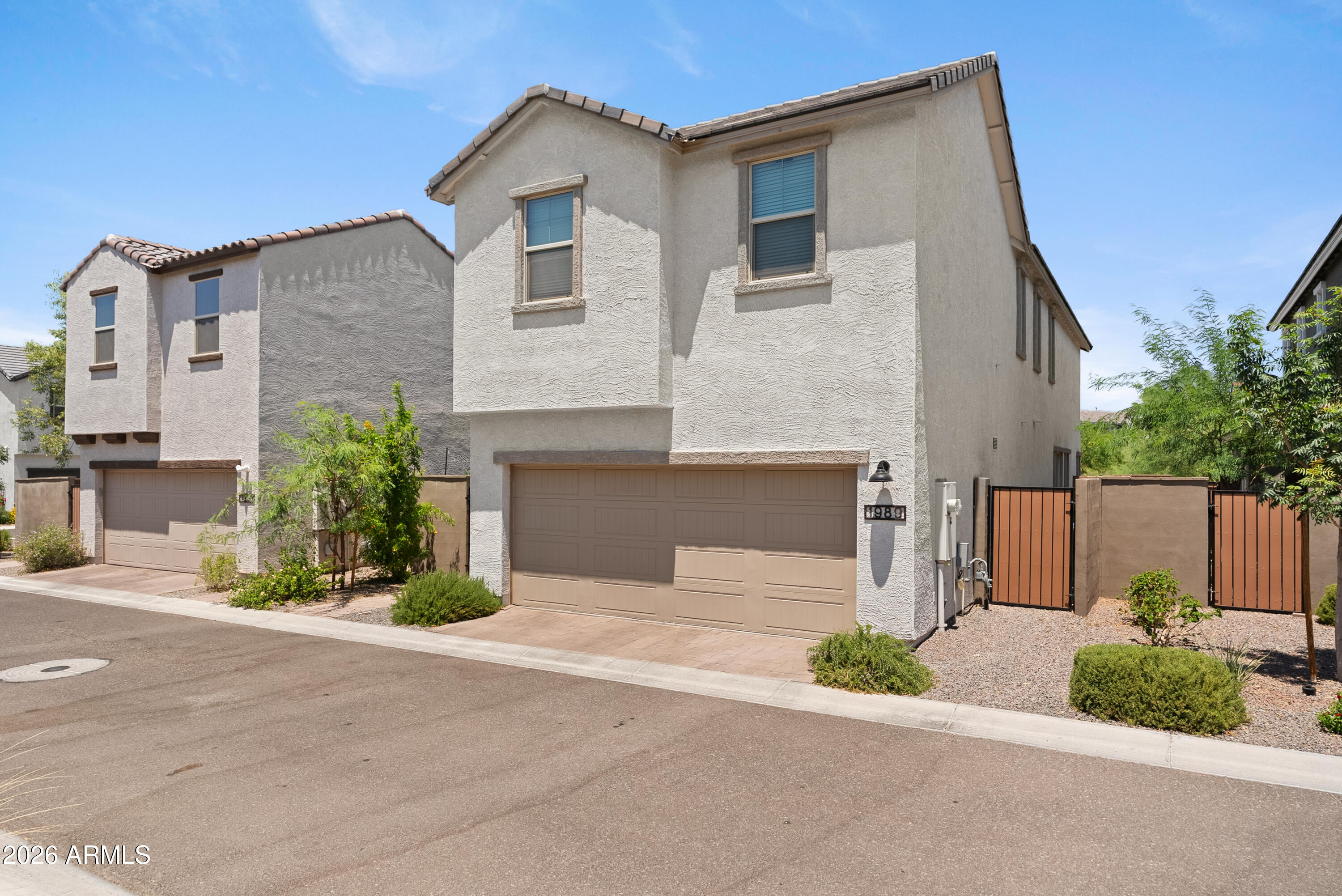 1989 West Hide Trail Phoenix, AZ 85085 - Photo 1 of 41 a front view of a house with a yard and garage