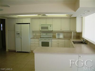 15551 Shell Point Boulevard Fort Myers, FL 33908 - Photo 4 of 9 a kitchen with a refrigerator and a sink