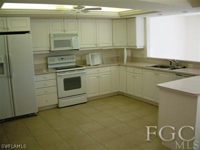 15551 Shell Point Boulevard Fort Myers, FL 33908 - Photo 5 of 9 a kitchen with a stove cabinets and a refrigerator