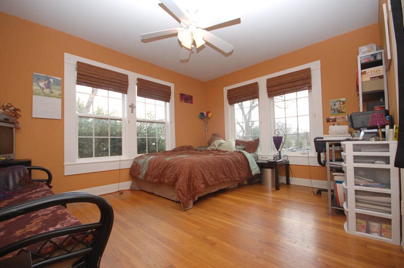 a spacious bedroom with a large bed and a large window