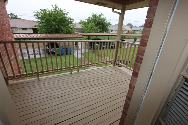 a view of balcony with wooden floor