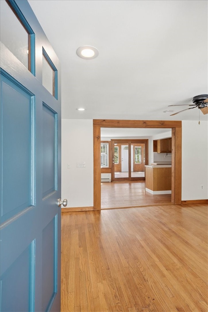 322 Rocky Hill Road Scituate, RI 02857 - Photo 8 of 50 Welcoming entry with direct sightlines into the main living areas, showcasing the home’s open layout and beautiful hardwood flooring.