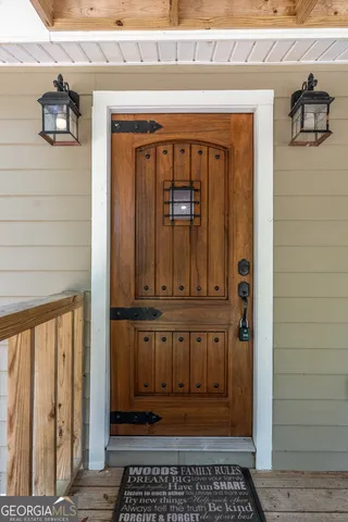 a view of a house with a wooden deck