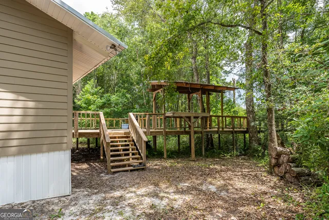 a view of a house with a wooden deck