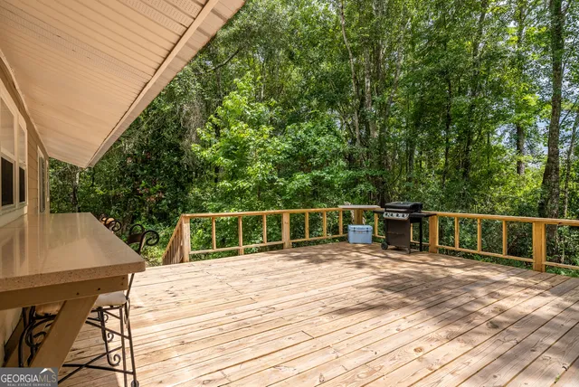 a view of balcony with wooden floor and fence