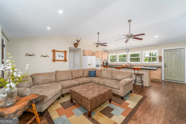a large kitchen with stainless steel appliances granite countertop a sink stove and cabinets