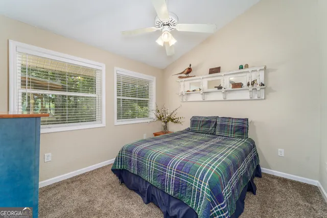 a kitchen with a sink a window and cabinets