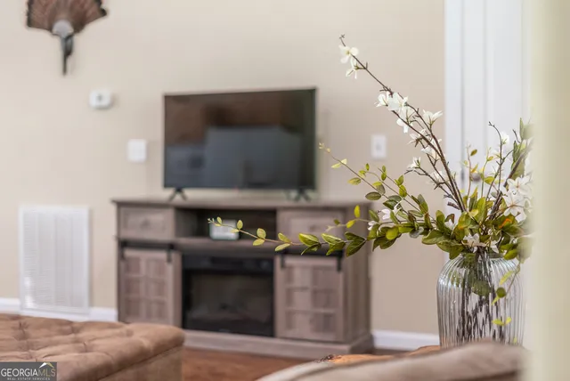 a view of a patio with table and chairs with wooden fence and plants