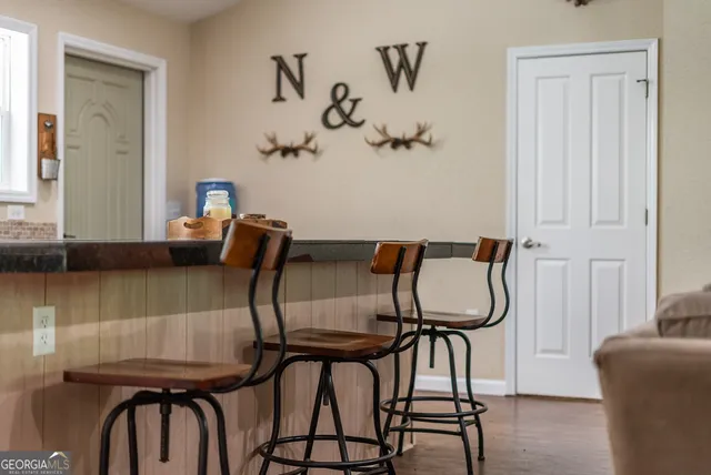 a view of swimming pool with lawn chairs and plants